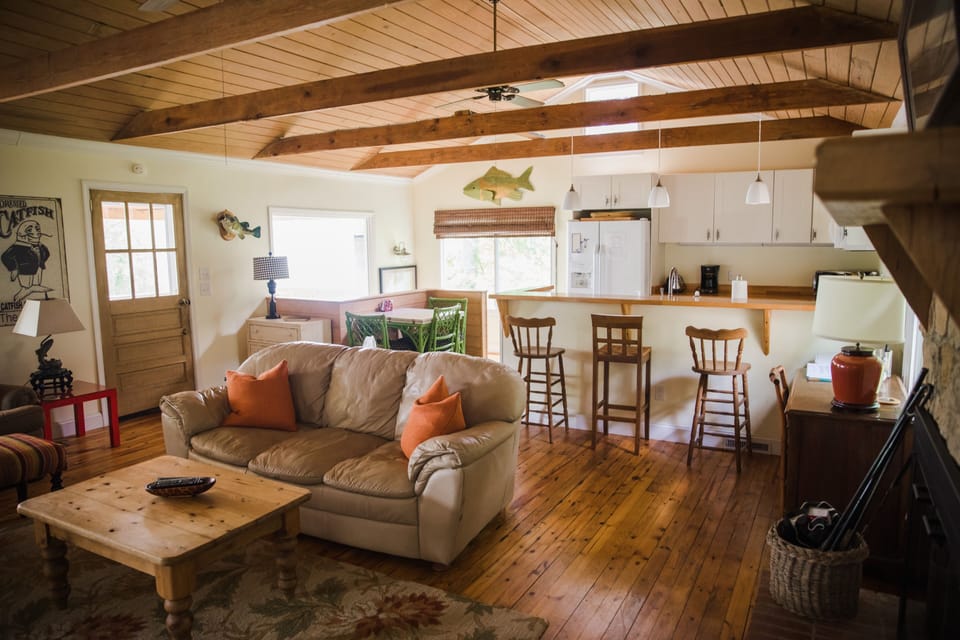 Main floor living and kitchen area. 2 couches, flat screen tv and open kitchen. 