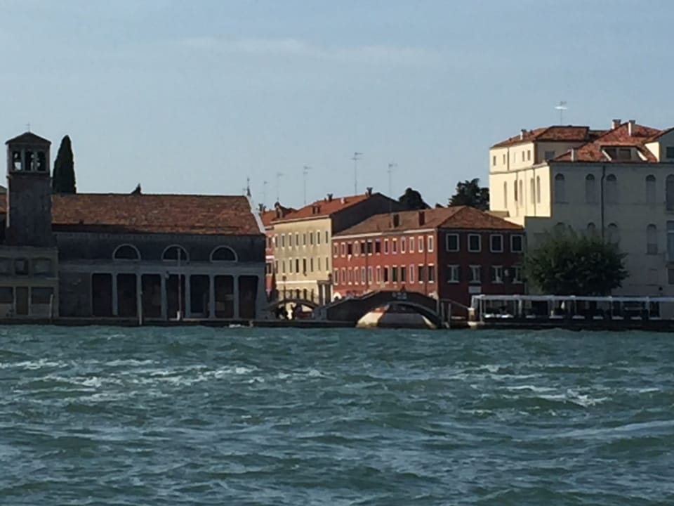 Giudecca Riva Apartment (rose pink building with bridge in the foreground)