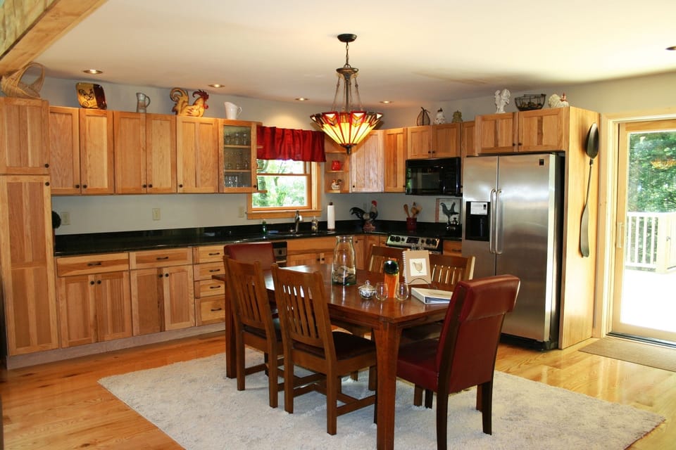Granite, stainless and hickory kitchen. Stickley heirloom table.