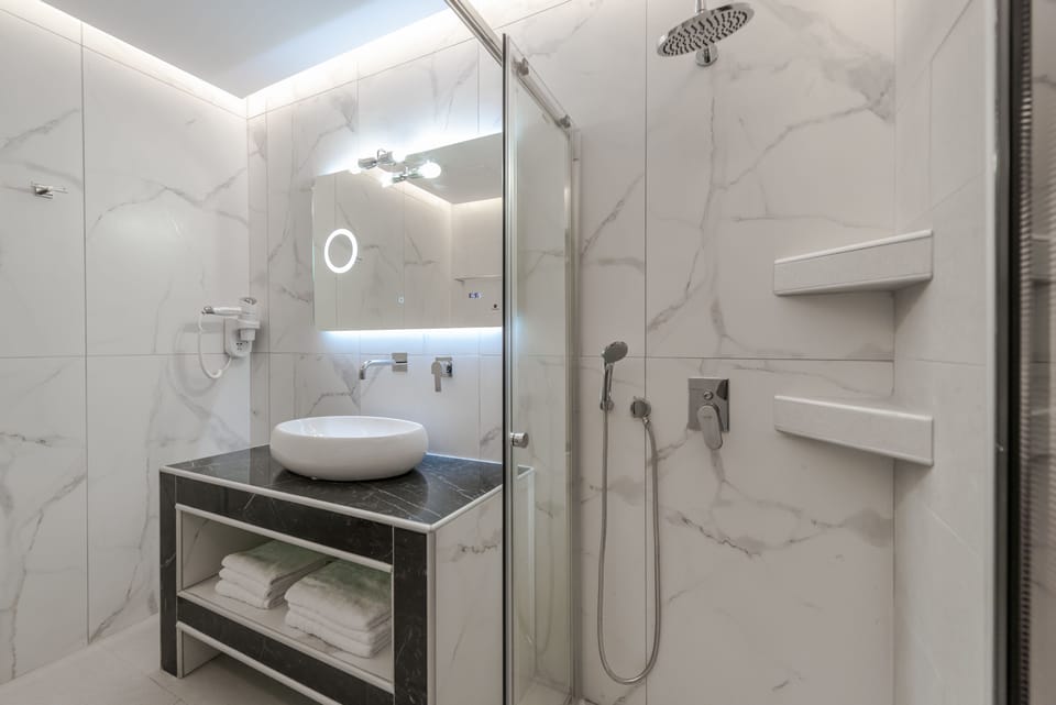 Suite, Sea View | Bathroom | Hair dryer, towels
