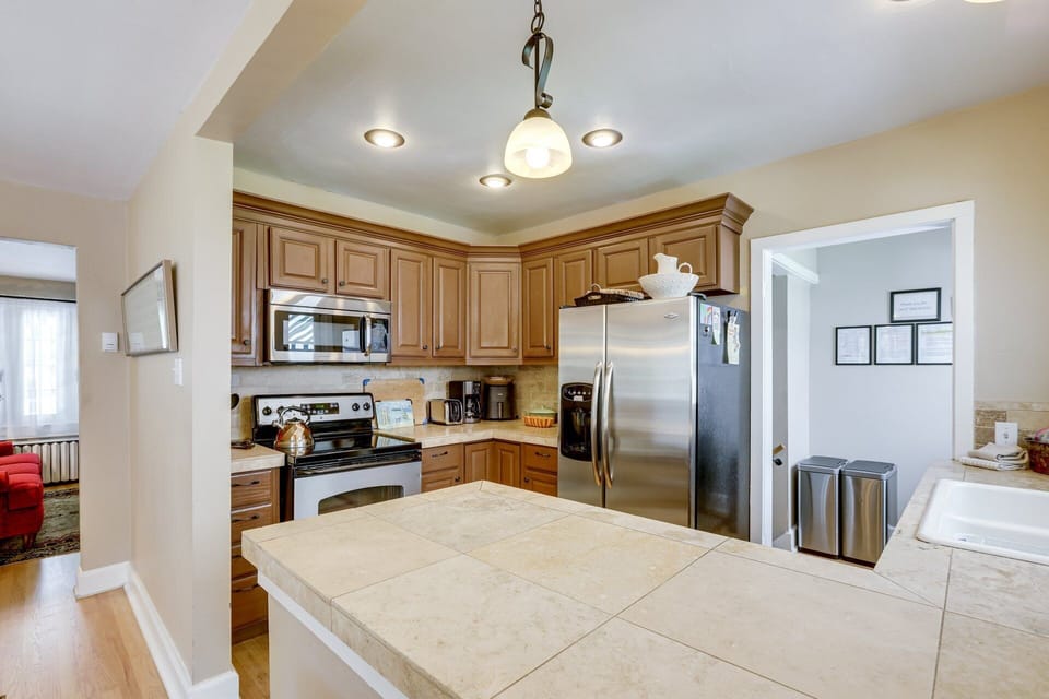 Kitchen refrigerator. Trash, recycle. Entry to steps to lower level & back yard.