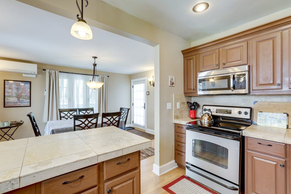 Kitchen, stove, microwave, dining room south facing window. 