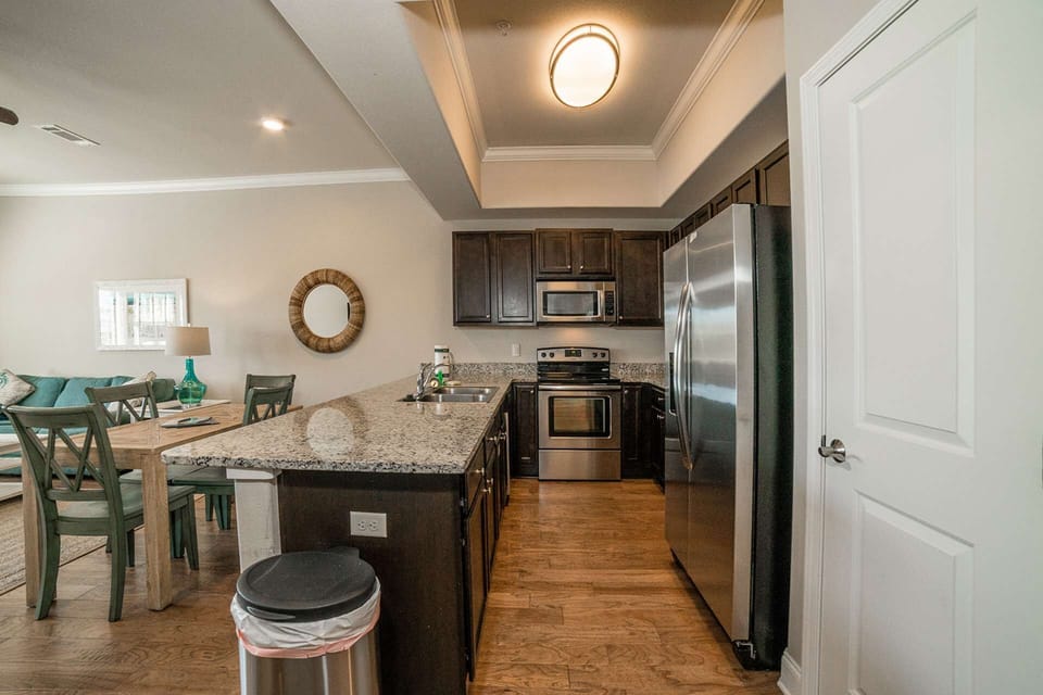 Fully equipped kitchen with stainless steel appliances and granite counters