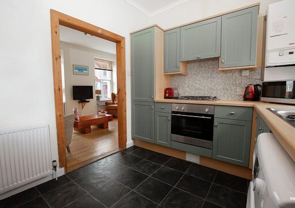 Fully stocked kitchen looking into living room 