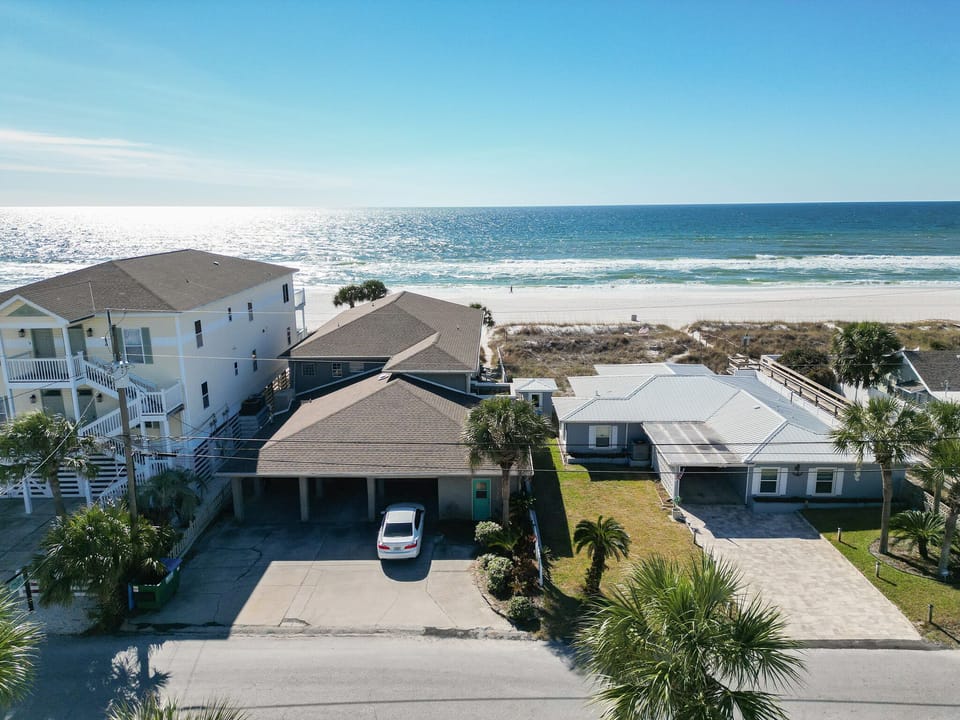 Locate4d Directly on Panama City Beach Parking for 5 - 6 vehicles 3 spots are covered (Center House White Car)