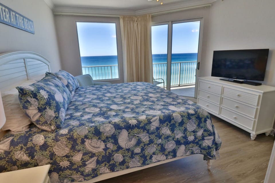 Flat screen TV in the master bedroom and access to the private balcony.