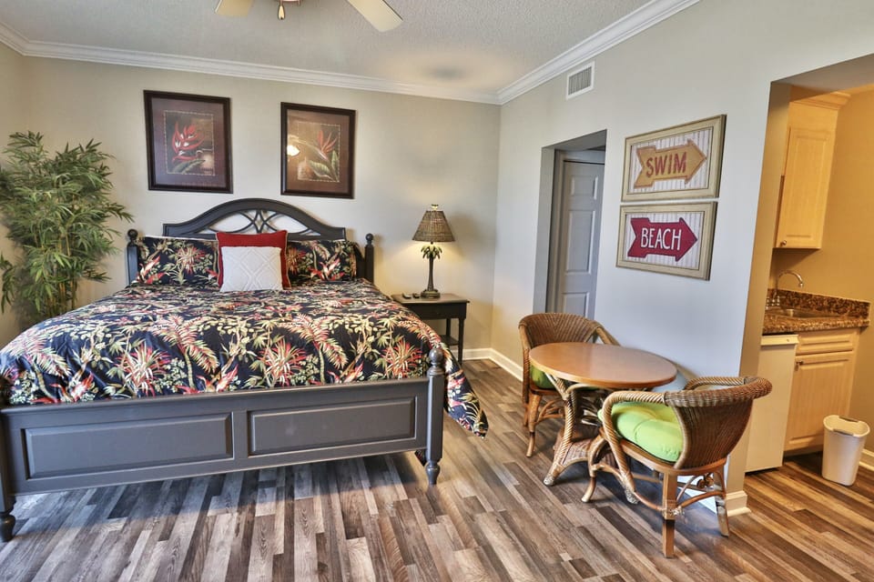 Lockout suite/4th bedroom with a king size bed, small dining table and kitchenette.