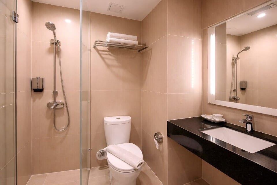 Shower, hair dryer, slippers, towels