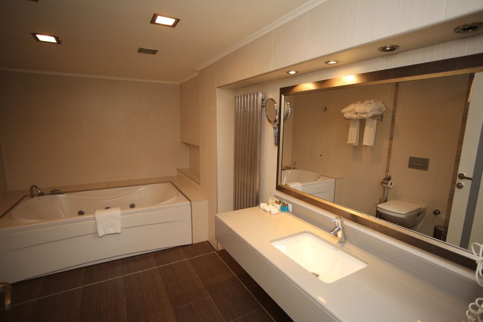 Deluxe Room | Bathroom | Hair dryer, slippers, towels, soap