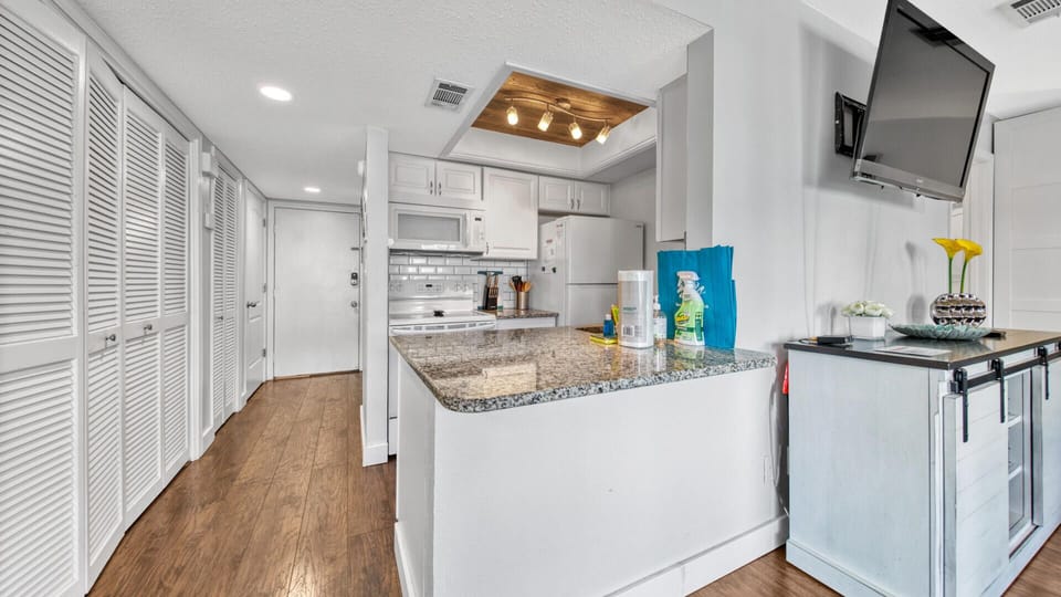 Kitchen With Pass-Through Granite Countertops and Breakfast Bar