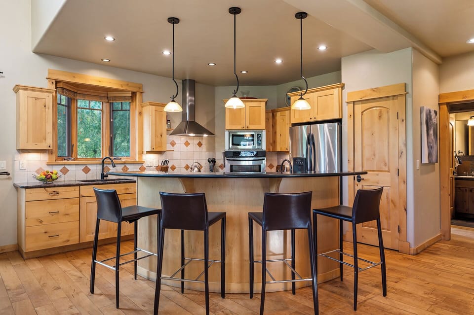 Open concept kitchen and dining areas & seating for four at the breakfast bar