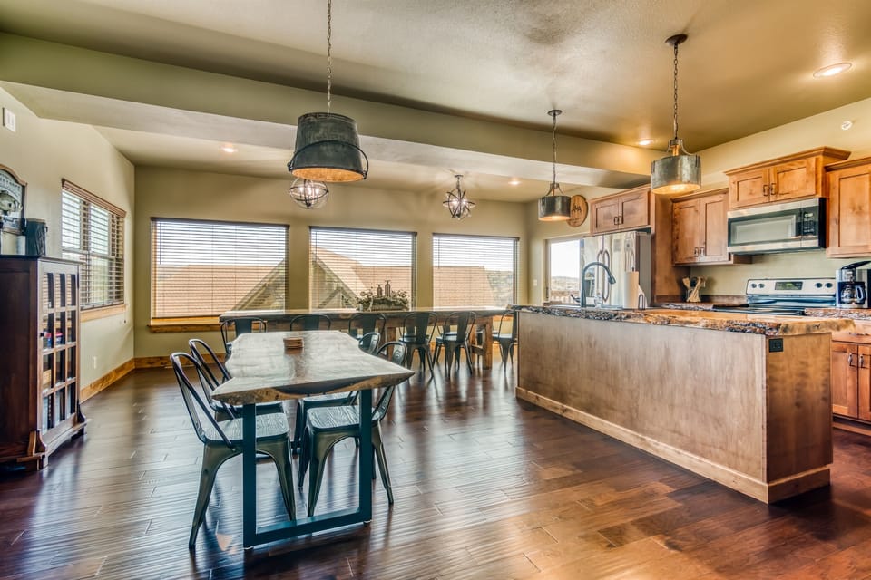 Open kitchen with lots of seating around the handmade live edge tables