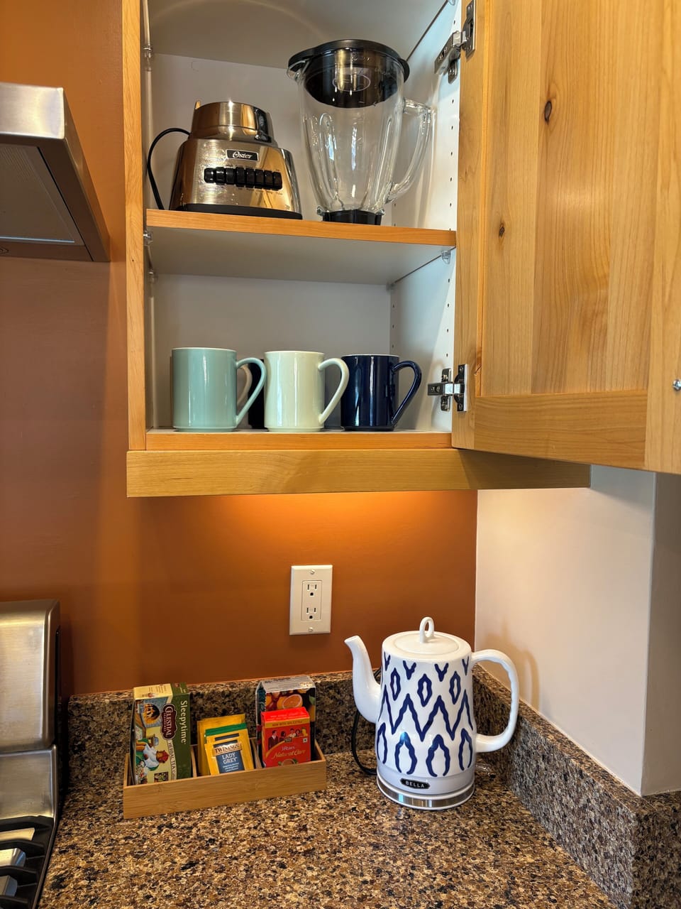 Blender, tea kettle, tea, and coffee mugs.