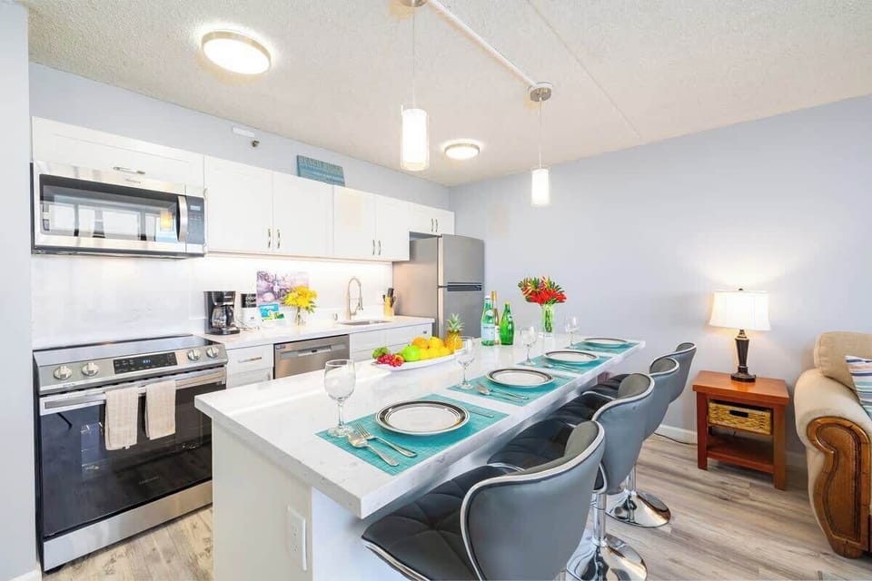 Fully equipped kitchen with dishwasher, cook top stove and oven, refrigerator, and microwave 