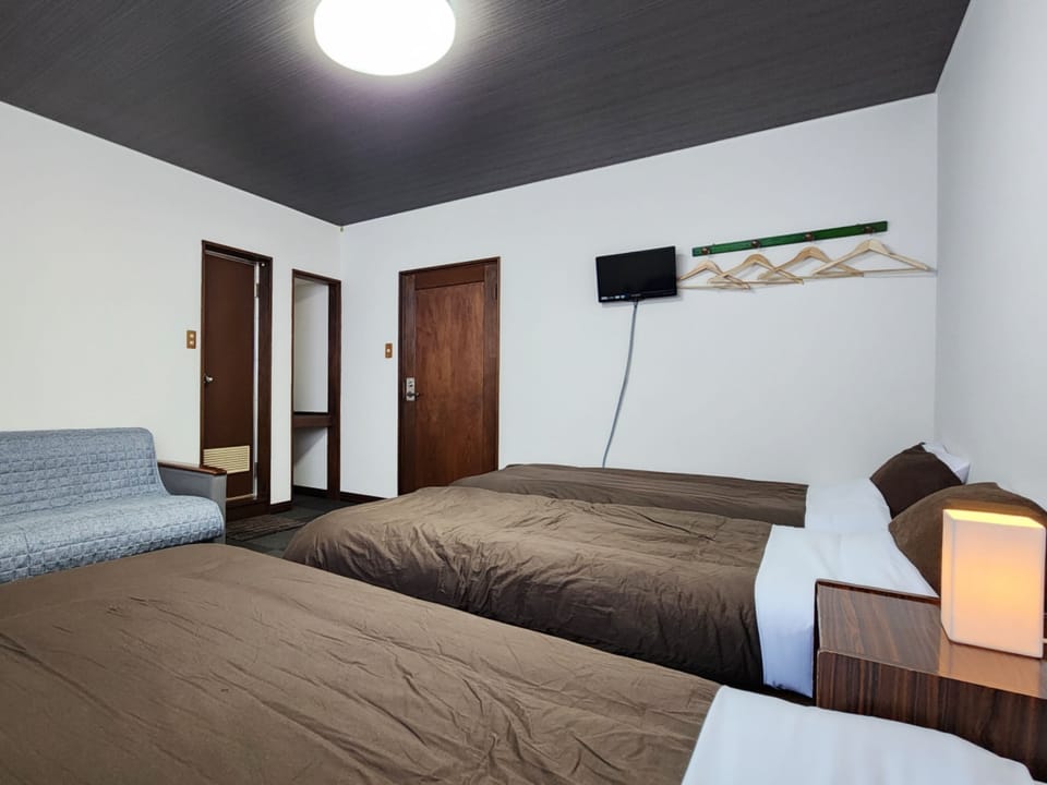 Triple Room, Non Smoking, Private Bathroom | Iron/ironing board, bed sheets