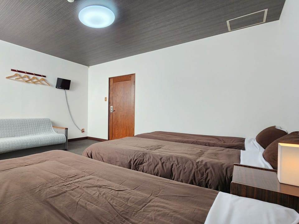 Triple Room, Non Smoking, Shared Bathroom | Iron/ironing board, bed sheets
