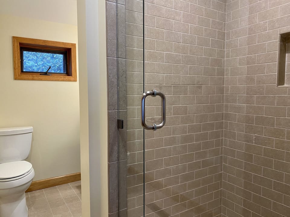 Main floor Bathroom with walk-in shower; designer tile throughout