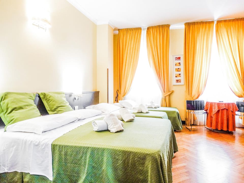 Quadruple Room | Minibar, in-room safe, desk, iron/ironing board