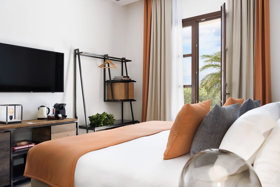 Suite, Garden View | Premium bedding, minibar, in-room safe, desk