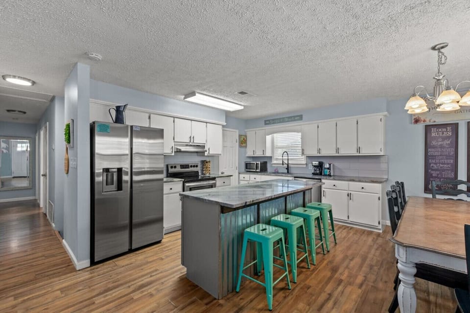 Gather around our spacious kitchen island table, a focal point for culinary adventures and lively conversations, where every meal becomes a shared experience in the heart of our home