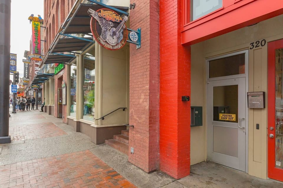 This is where you enter the building up to your lofts! (Left of the Boot Barn entrance, under the red framing).