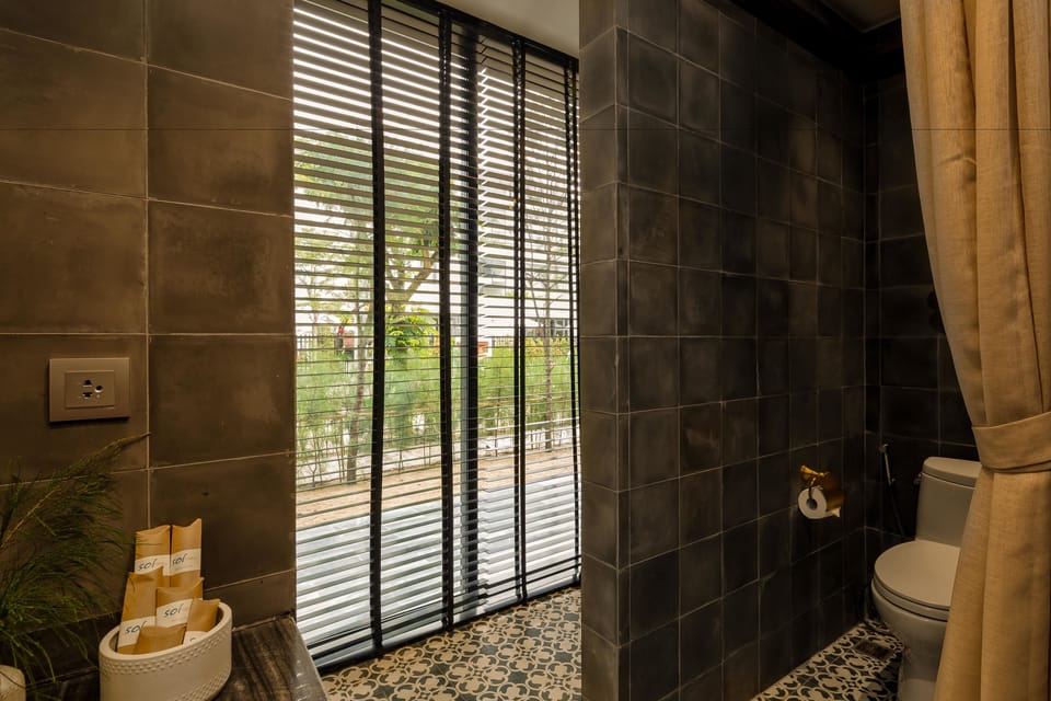 Deluxe Room, City View | Bathroom | Designer toiletries, hair dryer, bathrobes, slippers