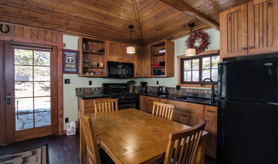 Updated kitchen with gas range, microwave, refrigerator and dishes