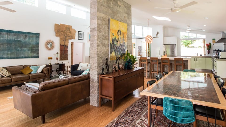 View of the interior from the front door. Dining, kitchen and lounge areas.