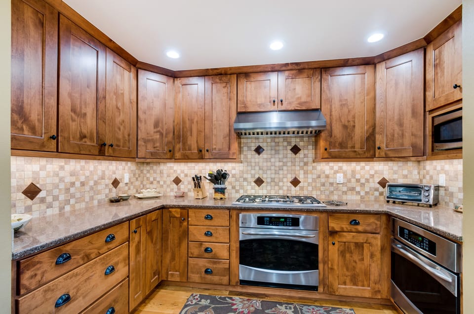 Kitchen with five burner cooktop, two convect ovens.

