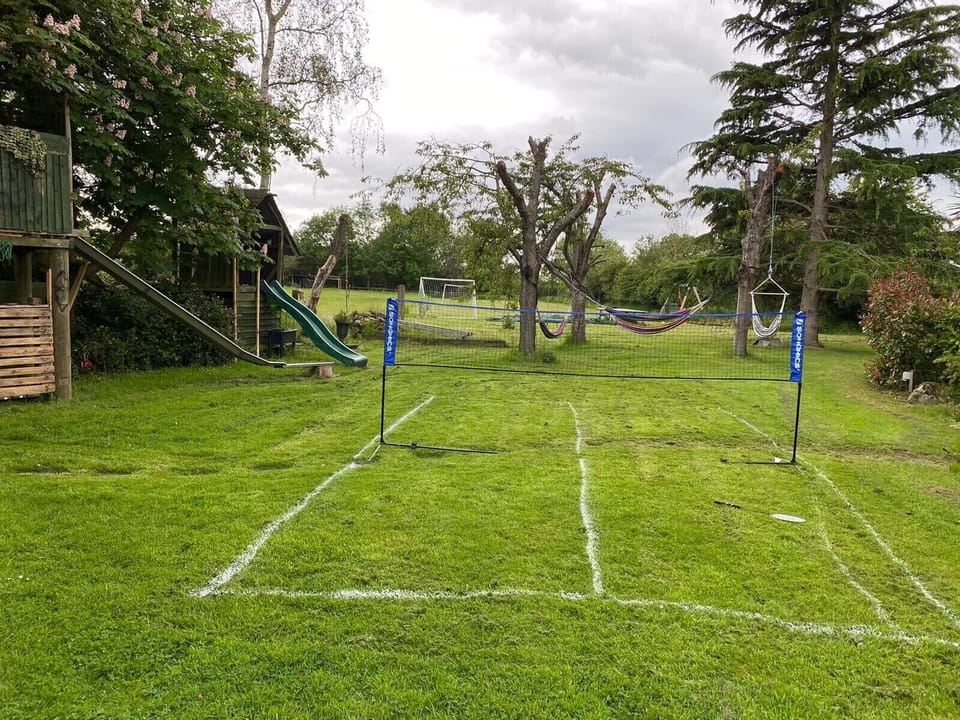 Badminton court, slides, swings and in-ground trampoline 