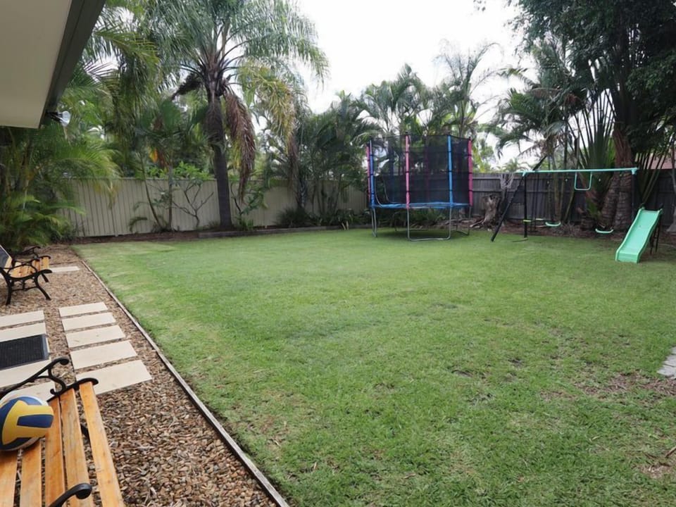 Huge manicured grassed area with play equipment 