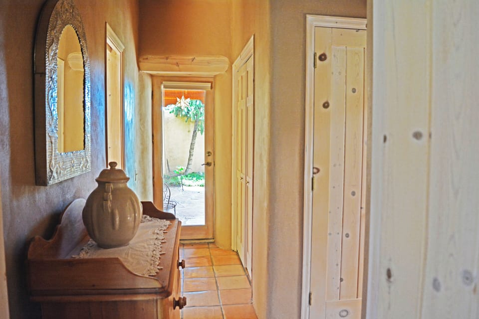 Hallway view to front enclosed patio and portal (covered walkway) to attached studio guest house casita.