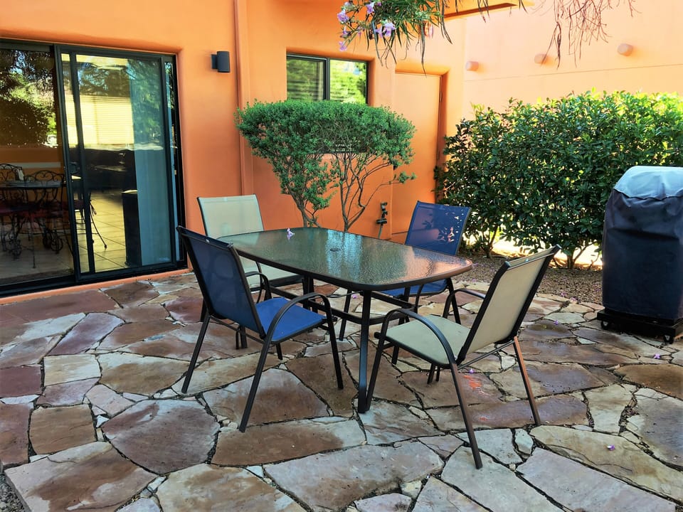 Backyard Patio with Local Stone, Glass Table, and BBQ