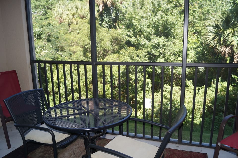Screened porch with nature view.