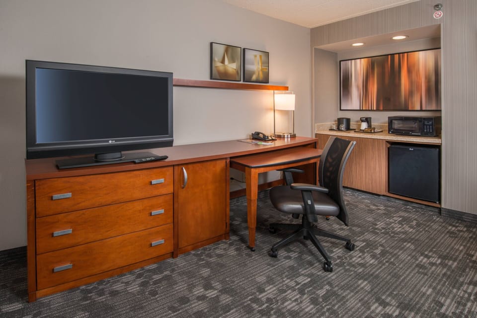 Premium bedding, desk, laptop workspace, blackout drapes
