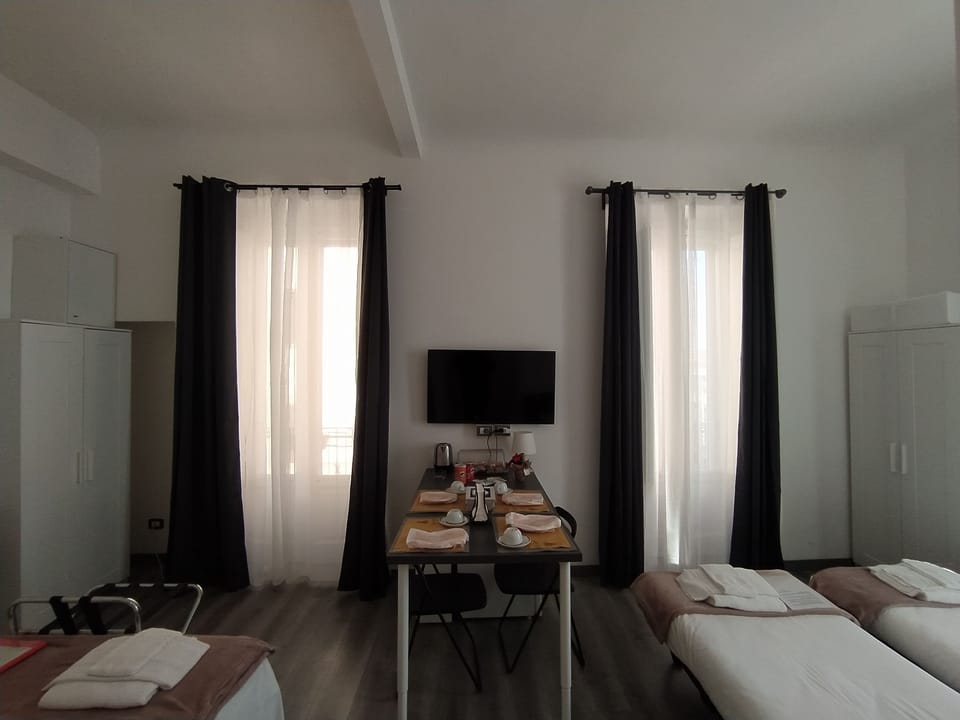 Deluxe Quadruple Room, Private Bathroom, City View | 4 bedrooms, down comforters, minibar, in-room safe