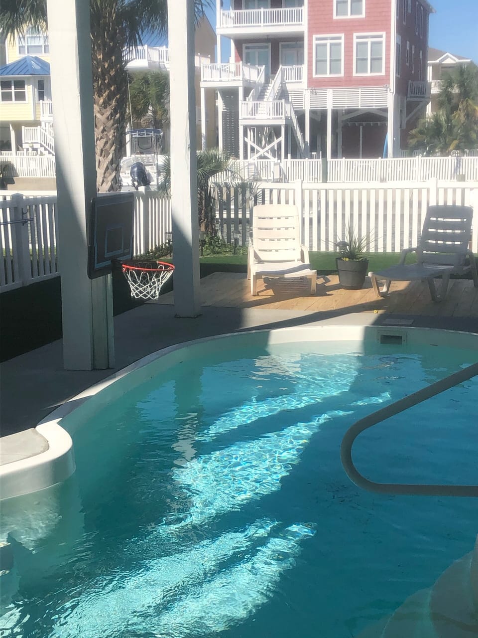 Swimming pool with basketball goal