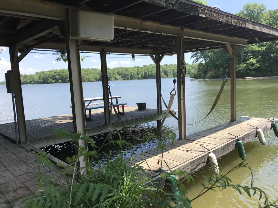 Fixed shore dock for your boat, with electric. (Sling lift for owner's boat.)