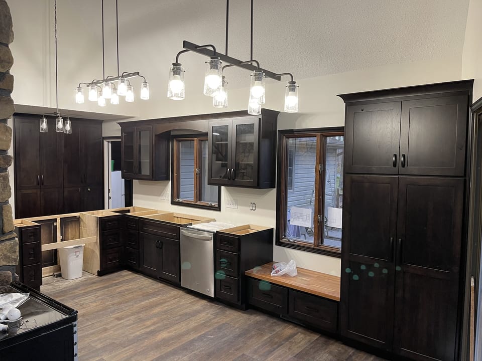 Lots of new lights, dishes, & pans. Small appliances are in tall cabinet.