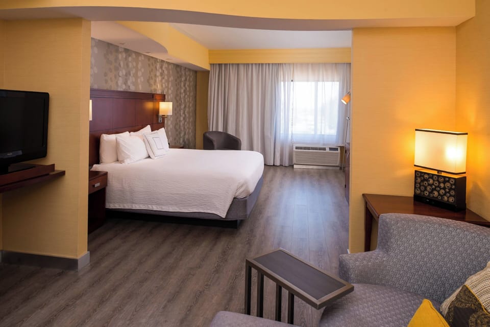 Premium bedding, desk, laptop workspace, blackout drapes