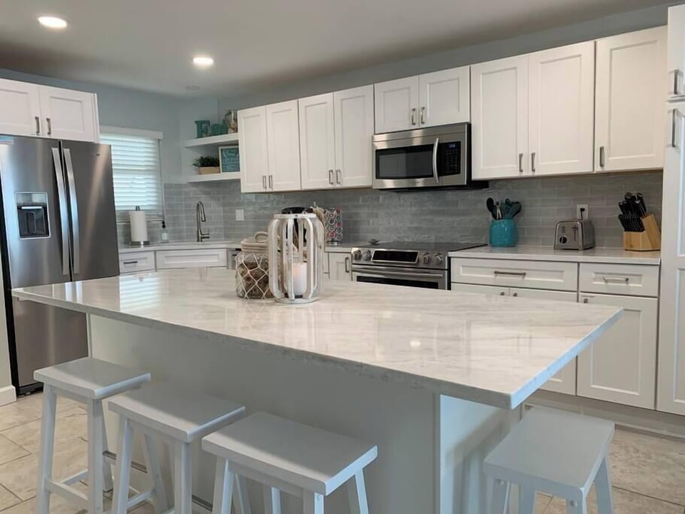 Open Concept Kitchen with expansive island and all stainless steel appliances