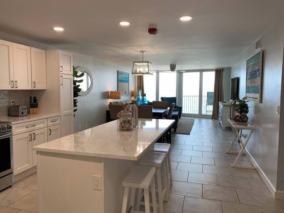 Open Concept Kitchen with large island and stainless steel appliances with views all the way to ocean