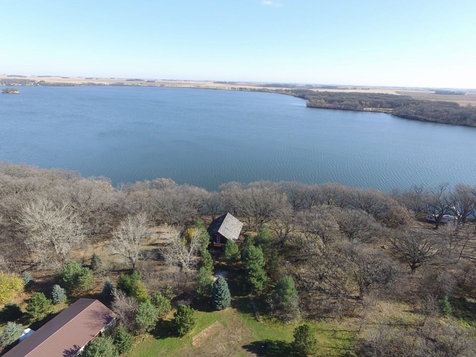 Aerial view of cabin and Loon Lake in autumn