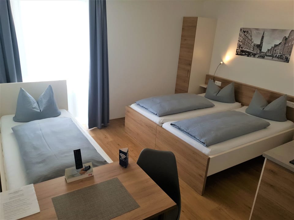 Triple Room | Down comforters, in-room safe, desk, blackout drapes