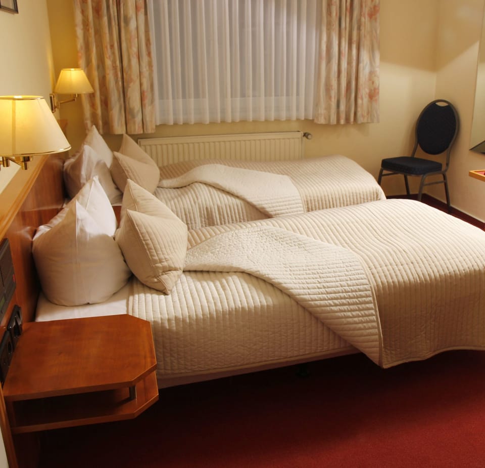 Hypo-allergenic bedding, desk, laptop workspace, blackout drapes