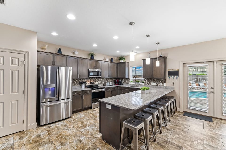 This kitchen has beautiful graphite-colored cabinetry and granite countertops.