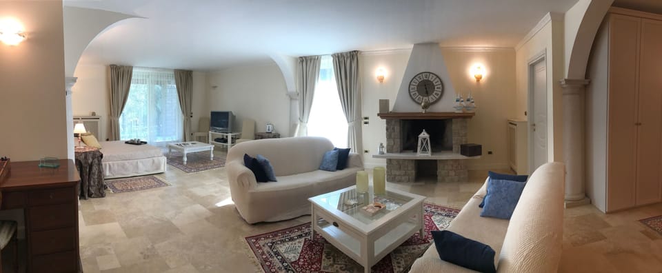 Superior Suite, Garden View | Living room | Flat-screen TV