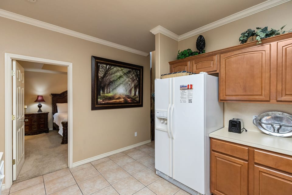 Your kitchen offers warm wood cabinets and modern appliances for preparing home-cooked meals during your stay.