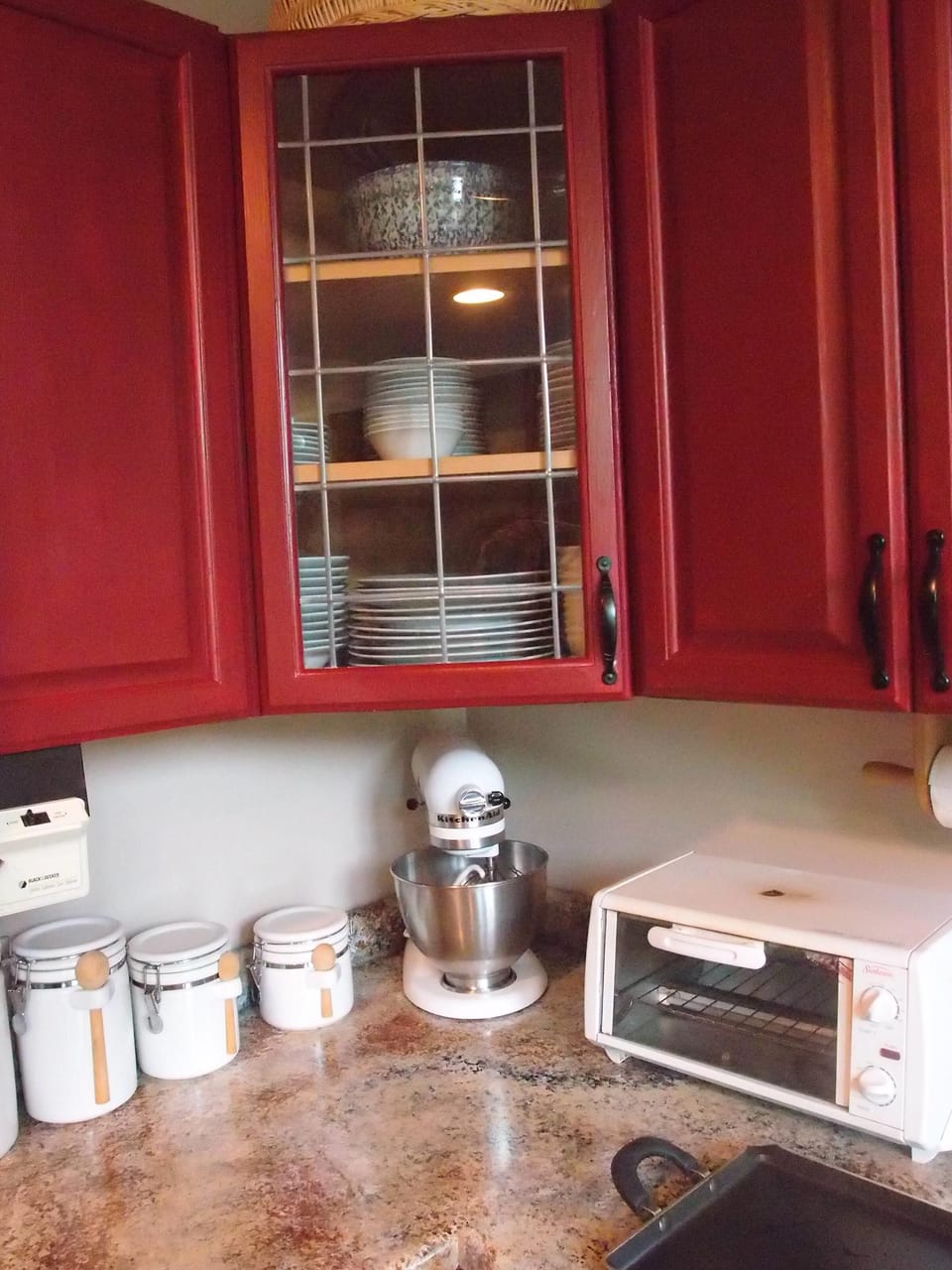 Kitchen Aid mixer for those that love to bake!  Cabinets are  stocked w/spices.