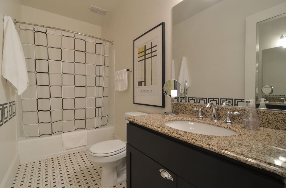 The charming bath boasts good light, a hair dryer and magnifying mirror.